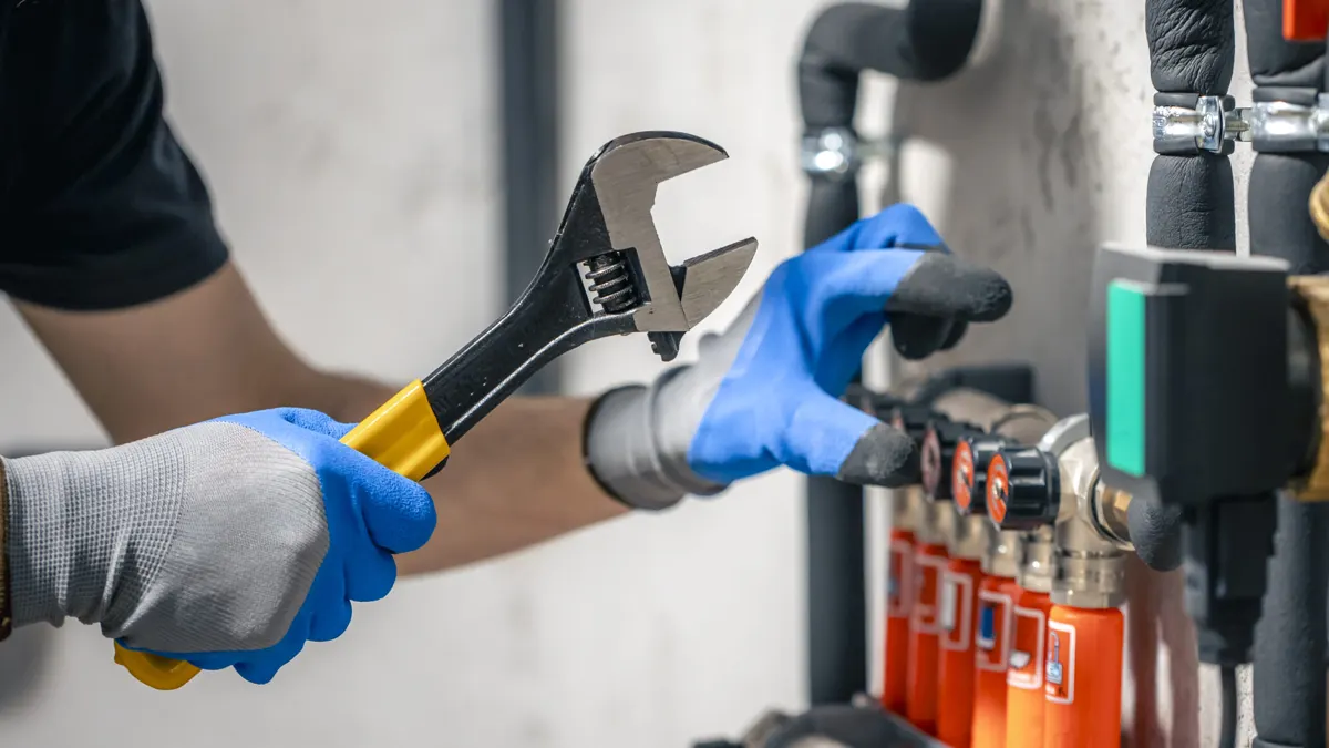 Plumber repairing pipework under a sink